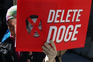 A demonstrator in New York City stops an anti-musk poster